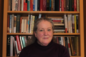 Image of Kimberly Jensen in front of bookshelf